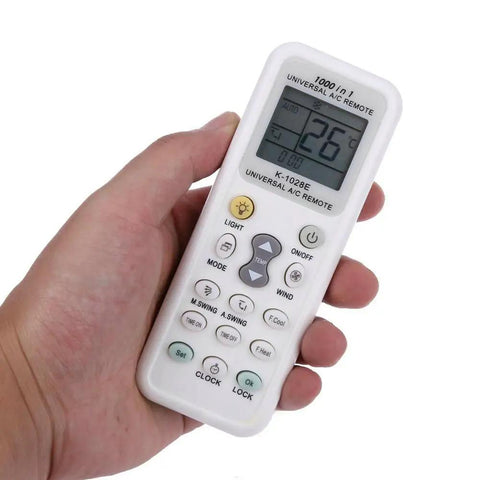 Person holding Universal LCD Remote For Air Conditioners All In One 1000 In 1 Controller Works With Most Brands Easy Setup English Manual Included Requires 2 AAA Batteries Backups For Home Comfort showing 26 degrees on screen.