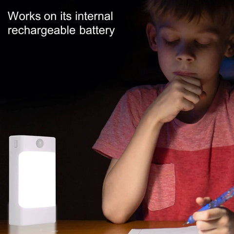 Child studying with a 4 In 1 LED Night Light With Motion Sensor And Dusk To Dawn, showing its rechargeable battery feature.