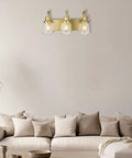 Three Light Sleek Brushed Nickel Vanity Fixture With Clear Glass Shades Over Mirror For Modern Bathroom Lighting