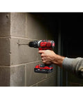 Heavy Duty Cordless Half Inch Hammer Drill Driver Kit Operating As A No Hassle Workhorse with a person using it on concrete.