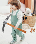 Child holding foam pickaxe prop for kids' costume, a lightweight miner tool toy for dress up, measuring approximately nineteen inch.