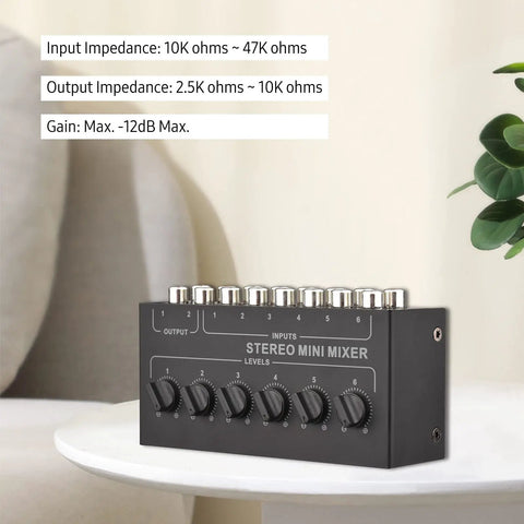 Compact Six Channel Passive Stereo Mixer With RCA Inputs and Two Channel Output on table, black metal design, no battery needed.