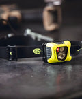 Enduro Pro 200 Lumen USB Rechargeable LED Headlamp with Elastic Head Strap, yellow design on workbench