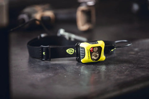 Enduro Pro 200 Lumen USB Rechargeable LED Headlamp with Elastic Head Strap, yellow design on workbench