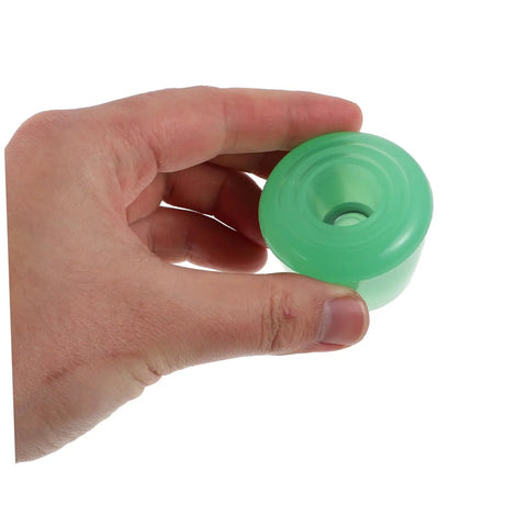 Holding a single light green PU Toe Stop Replacement Pair For Quad Skates With PU Brake Pads No Fuss Install.