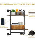 Heavy Duty Two Tier Industrial Pipe Wall Shelves With Rustic Wood And Vintage Towel Bar Straight Up Awesome Go To Storage Option For Bathroom And Farmhouse Living Room Decor displaying towels and décor.