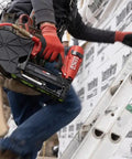 Heavy Hitter Pneumatic Cap Stapler Featuring A Rock Solid Three Eighths Inch Crown And Eighteen Gauge Design With Top Load Magazine used on ladder for roofing tasks.
