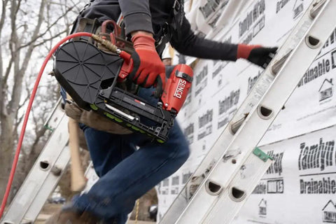 Heavy Hitter Pneumatic Cap Stapler Featuring A Rock Solid Three Eighths Inch Crown And Eighteen Gauge Design With Top Load Magazine used on ladder for roofing tasks.