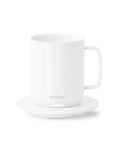 Keep Your Morning Brew Piping Hot With This App Controlled Smart Mug 10 Ounce White Heated Coffee Cup on charging base.