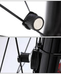 Two Pack Bike Speedometer Wheel Magnets For Spoke Sensor attached to round bicycle spokes.