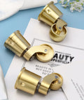 Solid Brass Furniture Casters Straight Up Heavy Duty Swivel Wheels Vintage Round Cup Base on blue background.