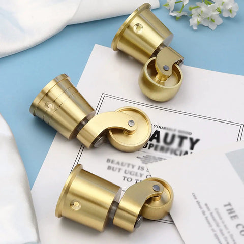 Solid Brass Furniture Casters Straight Up Heavy Duty Swivel Wheels Vintage Round Cup Base on blue background.