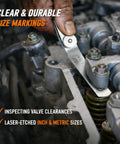Person using Pro Grade Stainless Steel Feeler Gauge Set With 32 Straight And 16 Angled Blades Dual Marked SAE And Metric Spark Plug Gap Tool in an engine.