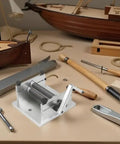 Wood Plank Bending Tool For Ship Models with toolbox, surrounded by model ship tools and wooden planks on a workbench.