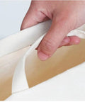 Hand holding the comfort handle of a Slim Fabric Storage Bin With Comfort Handles Narrow Closet Organizers For Shelf And Cabinet Durable Canvas.