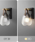 Fluted Glass Wall Sconce Ribbed Shade Leather Strap Brass Finish Metal Light 10 Inch Height in OFF and ON states mounted to wall.