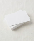 Heavy Duty 50 Piece Set Blank White Pvc Id Cards Dual Sided Printable with smart chip access stacked on a surface.