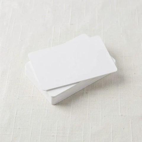 Heavy Duty 50 Piece Set Blank White Pvc Id Cards Dual Sided Printable with smart chip access stacked on a surface.