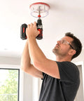 Man using Heavy Duty Adjustable Hole Saw Cutter Kit Twin Blade Drywall Tool for recessed lighting installation.