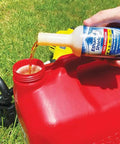 Pouring Fuel Stabilizer Twin Pack 24 Oz Keeps Gas Fresh Longer, Gasoline Treatment Additive into red fuel can