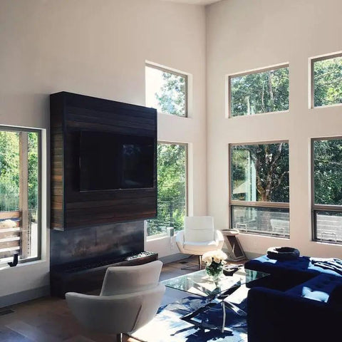 Modern living room with large windows, white chairs, and dark wood TV stand featuring Badass Mahogany Reactive Wood Stain For Knockout Deep Warm Brown.