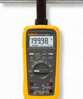 Pro Grade True RMS Digital Multimeter Kit With Premium Leads And ToolPak Hanging Kit, shown in use on a metal frame.