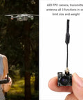 FPV All In One Camera With 5.8GHz 40CH 25mW Switchable Transmitter For Indoor Drone Racing shown in hand for scale