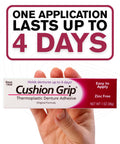 Hand holding Cushion Grip Thermoplastic Denture Adhesive box, 1 oz, zinc-free, indicating long-lasting snug fit for dentures.