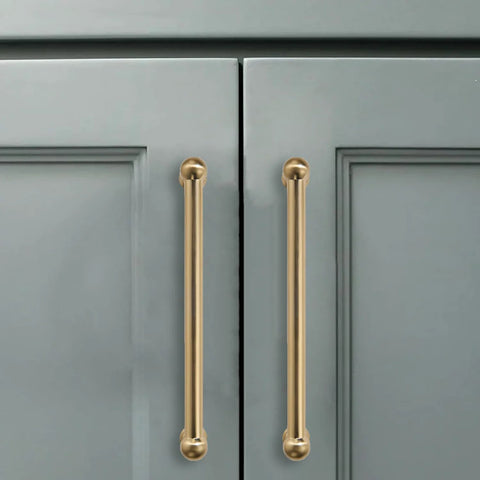 10 Pack 3-Inch Solid Zinc Alloy Cabinet Handles Brushed Gold Finish With Satin Brass Accents installed on grey cupboards