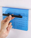 Hand holding pull against blue template from Cabinet Handle Drill Template Kit With Knob And Pull Templates And Three Sixteenth Inch Drill Bit