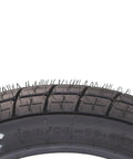 Close-up of 130/80-19 FT30 dirt bike front tube type tire treads for flat track racing, showing details for stable steering.