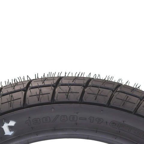 Close-up of 130/80-19 FT30 dirt bike front tube type tire treads for flat track racing, showing details for stable steering.