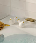 Sleek Ceramic Bird Toilet Bolt Covers Straight Up Upgrade Your Bathroom Vibe With Dope Rust Proof Screw Cap Decor For Bottom Toilet Base And Floor Hardware Accessories, displayed beside soap.