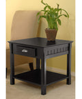 Round Beechwood End Table In Black Finish With Storage Drawer And Open Shelf, Rustic Modern Accent Piece, next to a sofa