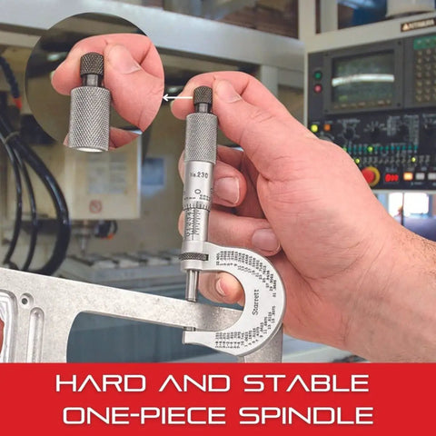 Hand holding Outside Micrometer With One-Piece Spindle And Tapered Frame, Satin Chrome Finish, in use on metal for precise measurement.