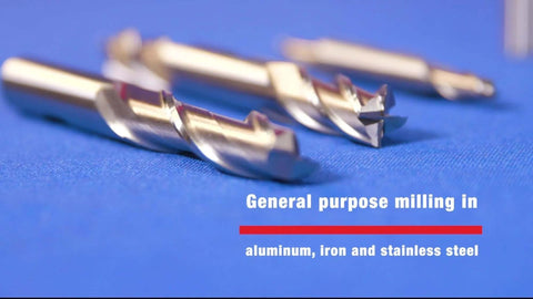 Close-up of four HSS 4-flute end mills, 1/2 in diameter, long center-cutting, on blue surface