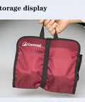 Climbing Quickdraw Hanging Storage Bag With Carabiner Hooks, Durable Waterproof Foldable Roll Bag in red color being held by hand