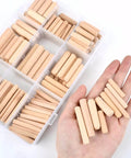 Hand holding assortment of wooden dowel pins from a box, part of Wooden Dowel Pins Set, 200 Pcs, Nine Sizes With Tapered Beveled Ends and Fluted Grooves.
