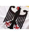 Close-up of a zipper on a garment with a black and red stylized eagle graphic design on a white background.