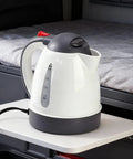 Heavy Duty 24V Electric Kettle For Trucks Built Like A Tank With Auto Shut Off 1 Liter Portable Water Heater on a table.