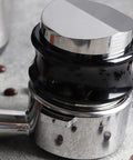 Dual Head Espresso Coffee Distributor And Adjustable Tamper With Bamboo Base on countertop with coffee beans, 51mm size.