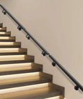 Rock Solid Wall Mounted Stair Handrail Premium Stainless Steel Safety Rail with Pre Drilled Mounting Holes, black rail on illuminated stairs.