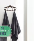 Knockout Five Hook Cast Iron Wall Hanger In Rustic Brown Fleur De Lis Farmhouse Entryway Coat Rack with towels hanging.
