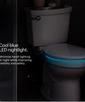 Premium Heated Elongated Toilet Seat With Built In Led Nightlight And Three Warmth Settings in a dark bathroom with cool blue light.