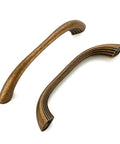 Close-up of 10 Pack Antique Brass Cabinet Pulls With Ergonomic Curved Grip, showcasing modern layered detailing for 5 inch kitchen cabinets.