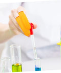 Person using Top Shelf 100 Pack Yellow Latex Finger Sleeves to hold a pipette in a lab setting while mixing liquids.
