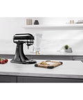 Gourmet Pasta Press Attachment for Stand Mixers with 6 interchangeable plates in white on kitchen counter