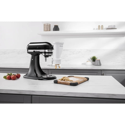 Gourmet Pasta Press Attachment for Stand Mixers with 6 interchangeable plates in white on kitchen counter