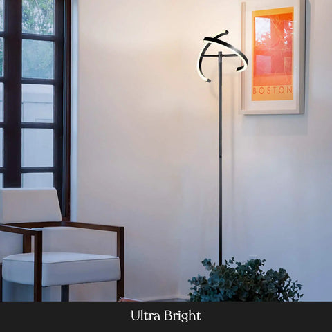 Halo Split LED Torchiere Floor Lamp Dimmable Bright Light Tall Standing Lamp For Living Room Or Office With Adjustable Rotating Light Rings Jet Black Finish And Modern Easy Style in a modern living room next to a white chair and art print.