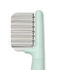 OXO Tot crinkle cutter for kids, mint-green handle with stainless steel ridged blade, close-up view